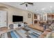 Spacious living room featuring a TV and seamless flow into the adjacent kitchen and dining area at 3058 E Spring Wheat Ln, Gilbert, AZ 85296