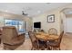 Cozy living area with a round dining table, recliner, and sliding glass doors leading to the patio at 3058 E Spring Wheat Ln, Gilbert, AZ 85296