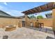 Outdoor kitchen area with a built-in grill, bar seating, and fire pit at 3058 E Spring Wheat Ln, Gilbert, AZ 85296