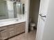 View of the bathroom with double sinks, tiled floors, and a toilet in a separate room at 3428 E Renee Dr, Phoenix, AZ 85050