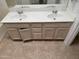 Bathroom with a double sink vanity, tiled floors, and white countertops at 3428 E Renee Dr, Phoenix, AZ 85050