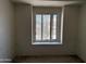 Empty bedroom with window providing natural light and view to the neighborhood at 3428 E Renee Dr, Phoenix, AZ 85050