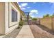 This charming backyard features desert landscaping, a pergola, and a quaint picket fence at 3855 W Denver St, Chandler, AZ 85226