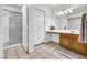 Bathroom featuring a vanity, a shower with glass door, and neutral tile flooring at 3855 W Denver St, Chandler, AZ 85226