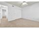 This bedroom features neutral carpet, a ceiling fan, and a large closet at 3855 W Denver St, Chandler, AZ 85226