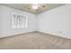 This bedroom features neutral carpet, plantation shutters, and a ceiling fan at 3855 W Denver St, Chandler, AZ 85226