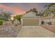 Charming single-Gathering home featuring an attached two-car garage and a well-manicured front yard at sunset at 3855 W Denver St, Chandler, AZ 85226