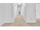 Bright hallway featuring neutral carpet, white walls, and arched doorways leading to various rooms at 3855 W Denver St, Chandler, AZ 85226