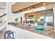 Bright kitchen featuring wood cabinetry, stainless steel appliances, and a stylish breakfast bar with countertop dining at 3855 W Denver St, Chandler, AZ 85226
