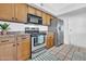 Kitchen featuring stainless steel appliances, wooden cabinets, and neutral flooring at 3855 W Denver St, Chandler, AZ 85226