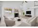 Virtually staged living room with fireplace, plenty of seating, and bright, natural light at 3855 W Denver St, Chandler, AZ 85226