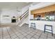 Open-concept layout with kitchen, staircase, and cozy living area with fireplace at 3855 W Denver St, Chandler, AZ 85226