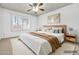 Virtually staged main bedroom with soft rug, a large bed, and natural light at 3855 W Denver St, Chandler, AZ 85226