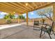 Covered patio with patio furniture and view of the desert landscaped backyard at 3855 W Denver St, Chandler, AZ 85226