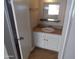 Bathroom vanity with granite countertop, white cabinets and large mirror at 413 E Bruce Ave # D, Gilbert, AZ 85234