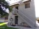 Two story condo building with private stairway, small table and chairs, and simple landscaping at 413 E Bruce Ave # D, Gilbert, AZ 85234