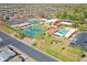 Overhead view of the community tennis courts and pool, along with the surrounding neighborhood at 453 S Parkcrest -- # 416, Mesa, AZ 85206