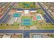 Overhead view of the community tennis courts and pool with golf course in the distance at 453 S Parkcrest -- # 416, Mesa, AZ 85206