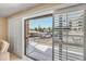 Open balcony featuring sliding glass doors with white shutters, tile flooring, and views of the community at 453 S Parkcrest -- # 416, Mesa, AZ 85206