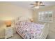 Bright bedroom with a floral comforter, ceiling fan, and plantation shutters at 453 S Parkcrest -- # 416, Mesa, AZ 85206