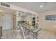 Dining area with glass table, mirrored wall, tile floor, and access to kitchen and living area at 453 S Parkcrest -- # 416, Mesa, AZ 85206