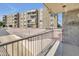 Exterior view from the balcony of a condo with palm trees, and well-maintained landscaping at 453 S Parkcrest -- # 416, Mesa, AZ 85206