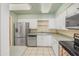 Kitchen with white cabinets, tile floors, stainless steel appliances and bright lighting at 453 S Parkcrest -- # 416, Mesa, AZ 85206