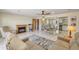Open-concept living room with fireplace, tile floors, ceiling fan and comfortable seating area near the kitchen at 453 S Parkcrest -- # 416, Mesa, AZ 85206