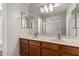 Bathroom featuring double sinks, a large mirror, and wood cabinets at 4942 W Novak Way, Laveen, AZ 85339