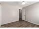 Neutral bedroom featuring wood-look floors and a white door at 4942 W Novak Way, Laveen, AZ 85339