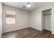 This bedroom features modern ceiling fan, a window with blinds, and wood-look floors at 4942 W Novak Way, Laveen, AZ 85339