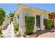 View of rear home exterior with brick pathway, small garden, and white stucco walls at 5112 N 32Nd Pl, Phoenix, AZ 85018