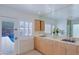 Bright bathroom featuring double sinks, large mirror, and a view of the pool at 5112 N 32Nd Pl, Phoenix, AZ 85018