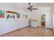 Spacious bonus room features tile flooring, a ceiling fan, and a wet bar with sink and cabinets at 5112 N 32Nd Pl, Phoenix, AZ 85018