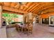 Inviting covered patio with fireplace, Saltillo tile floors, and wood-beamed ceiling at 5112 N 32Nd Pl, Phoenix, AZ 85018