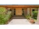 Welcoming entryway with double doors, brick accents, and lush landscaping at 5112 N 32Nd Pl, Phoenix, AZ 85018