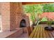 Outdoor fireplace on a covered patio featuring a brick design and dining area at 5112 N 32Nd Pl, Phoenix, AZ 85018