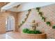 Living area showing a brick wall with fountain feature and manicured greenery at 5112 N 32Nd Pl, Phoenix, AZ 85018