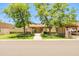Charming single-story home with mature trees, well-manicured lawn, and a covered carport at 5112 N 32Nd Pl, Phoenix, AZ 85018