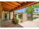 Inviting covered front porch with brick accents, potted plants, and a gated entry at 5112 N 32Nd Pl, Phoenix, AZ 85018