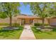 Charming single-story home with a brick wall and beautifully manicured landscaping at 5112 N 32Nd Pl, Phoenix, AZ 85018