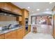 A spacious kitchen features wood cabinets, stainless steel appliances, and a breakfast bar at 5112 N 32Nd Pl, Phoenix, AZ 85018