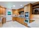 Well-lit kitchen features wood cabinetry, stainless steel appliances, and a marble tile floor at 5112 N 32Nd Pl, Phoenix, AZ 85018