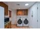 The laundry room is equipped with modern washer and dryer units at 5112 N 32Nd Pl, Phoenix, AZ 85018