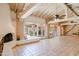 Expansive living area boasts terracotta tile, brick accents, exposed wood beams and multiple patio access points at 5112 N 32Nd Pl, Phoenix, AZ 85018