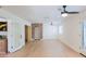 Spacious living room with hardwood floors, ceiling fans, and arched brick doorway at 5112 N 32Nd Pl, Phoenix, AZ 85018