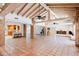 Large living area boasting terra cotta floors, brick accents, and exposed beam ceiling at 5112 N 32Nd Pl, Phoenix, AZ 85018