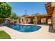 Backyard pool with a covered patio, an outdoor kitchen, and a spacious lounge area at 5112 N 32Nd Pl, Phoenix, AZ 85018