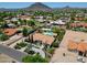 Large home with beautiful landscaping, circular driveway, tile roof, and lush backyard at 5320 W Soft Wind Dr, Glendale, AZ 85310