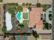 Aerial view showcasing a luxurious home with a pool, sports court, lush landscaping, and privacy at 5320 W Soft Wind Dr, Glendale, AZ 85310